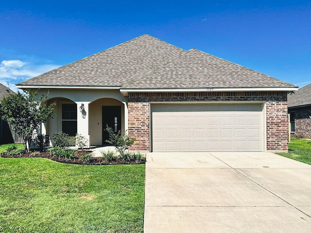 view of front facade with a garage and a front lawn