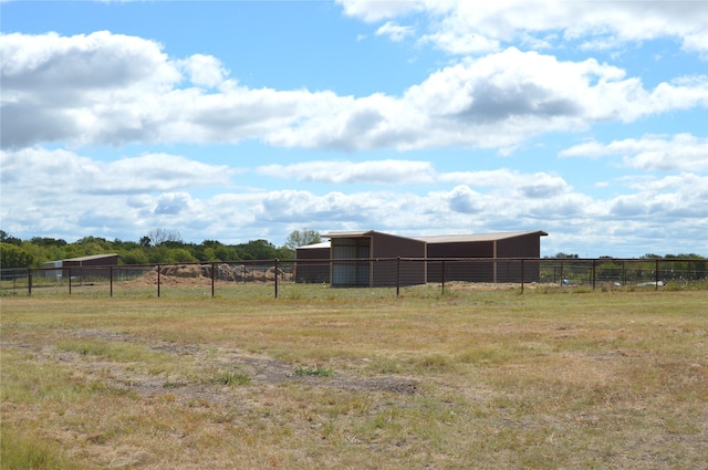 view of yard featuring an outbuilding and a rural view