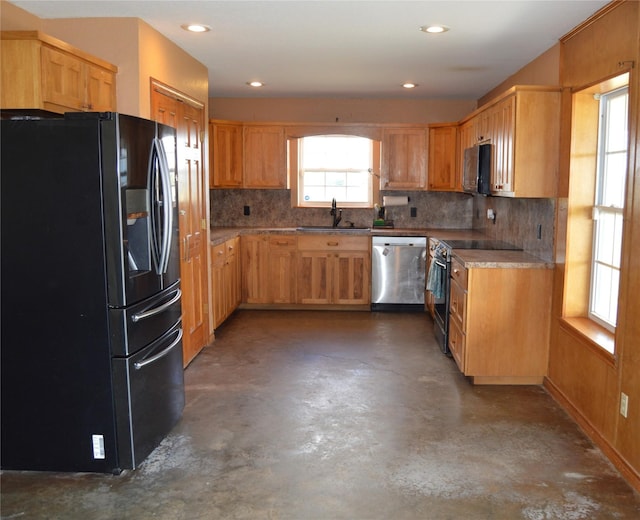 kitchen with a sink, black appliances, concrete flooring, decorative backsplash, and recessed lighting