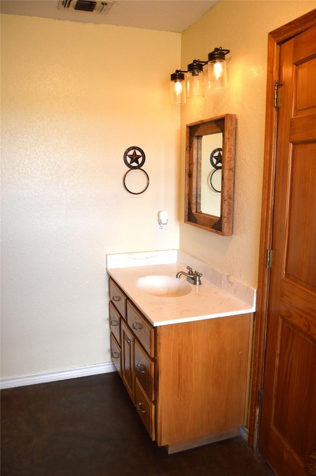 bathroom with baseboards, visible vents, and vanity