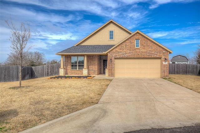 view of front of home featuring a garage and a front yard