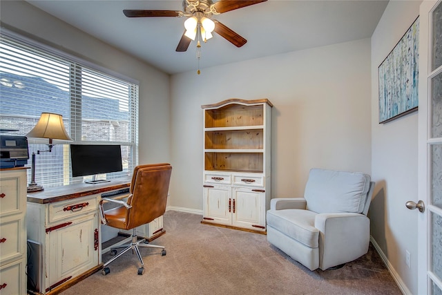 carpeted office space with ceiling fan