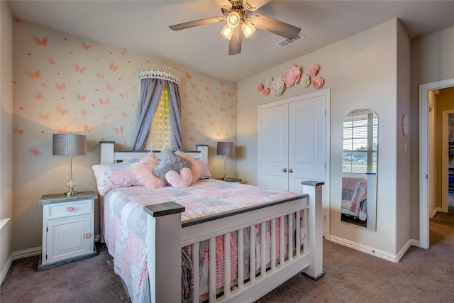 bedroom featuring ceiling fan, a closet, and dark colored carpet