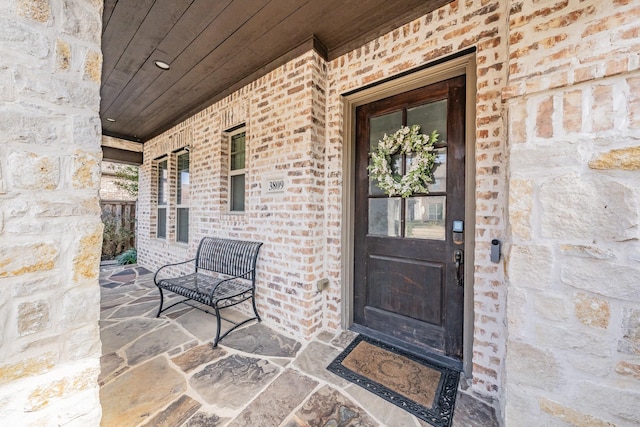 view of exterior entry featuring a porch