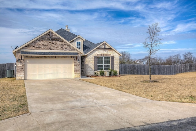 view of front facade featuring cooling unit, a garage, and a front lawn