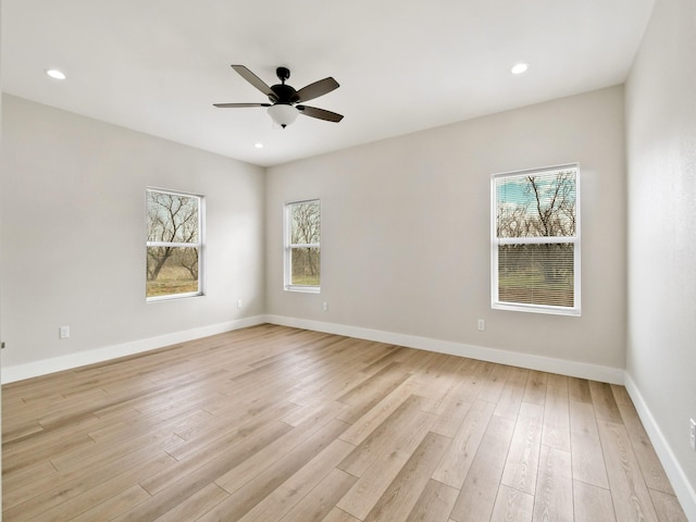 empty room with ceiling fan and light wood-type flooring