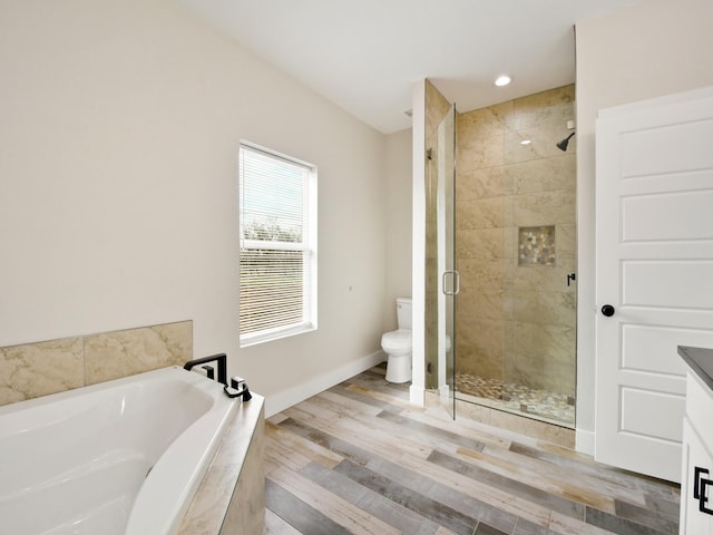 full bathroom with vanity, toilet, separate shower and tub, and hardwood / wood-style floors