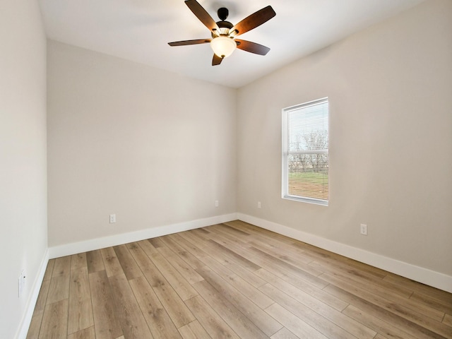 empty room with ceiling fan and light hardwood / wood-style floors