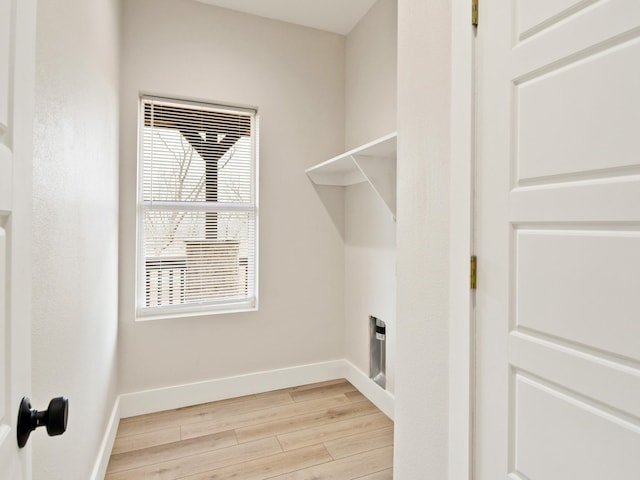 laundry room with light hardwood / wood-style floors