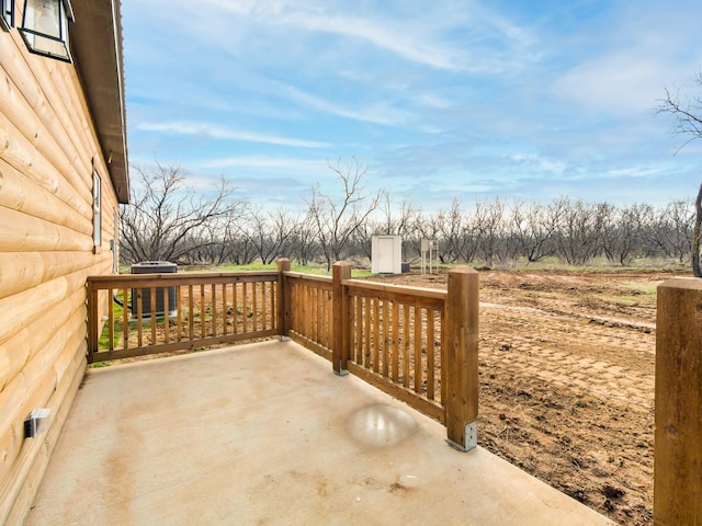 view of patio featuring a storage unit and central AC unit