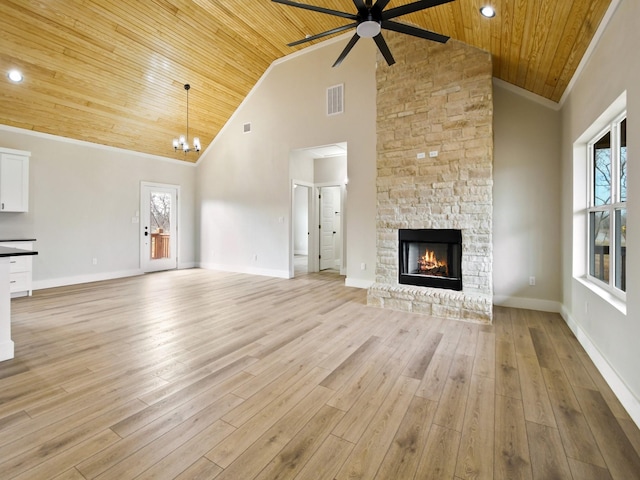 unfurnished living room with a fireplace, ornamental molding, light hardwood / wood-style floors, plenty of natural light, and wooden ceiling