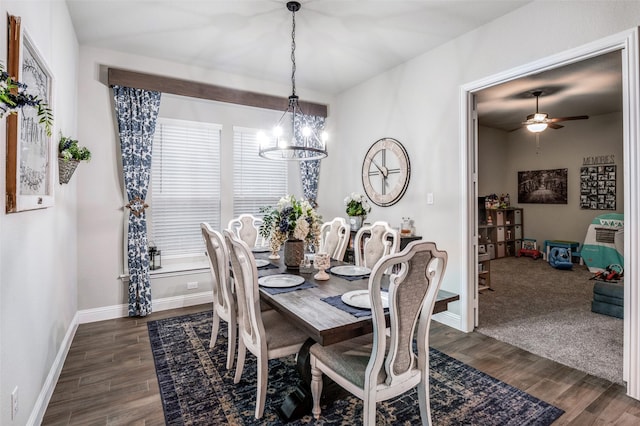 dining space featuring ceiling fan with notable chandelier and dark hardwood / wood-style floors