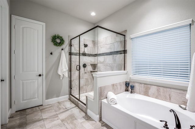 bathroom featuring separate shower and tub