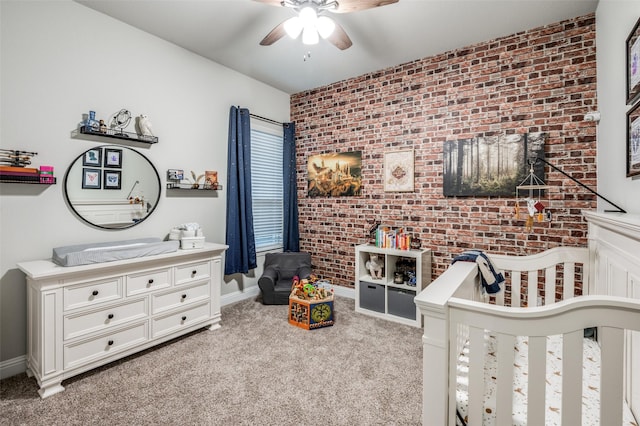 carpeted bedroom with ceiling fan and brick wall