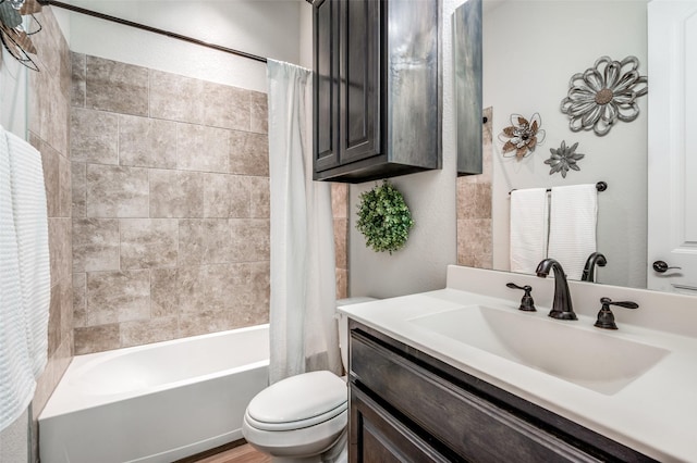 full bathroom with vanity, shower / tub combo, and toilet