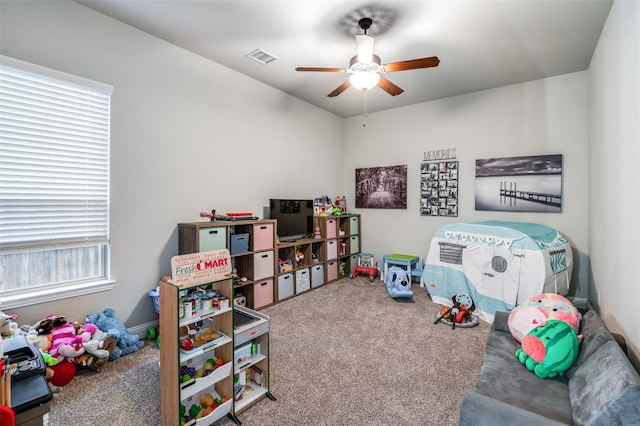 playroom with ceiling fan and carpet