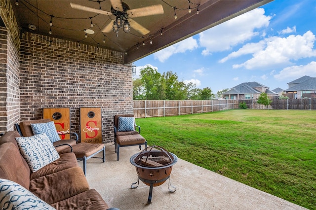 view of patio / terrace featuring ceiling fan and an outdoor fire pit