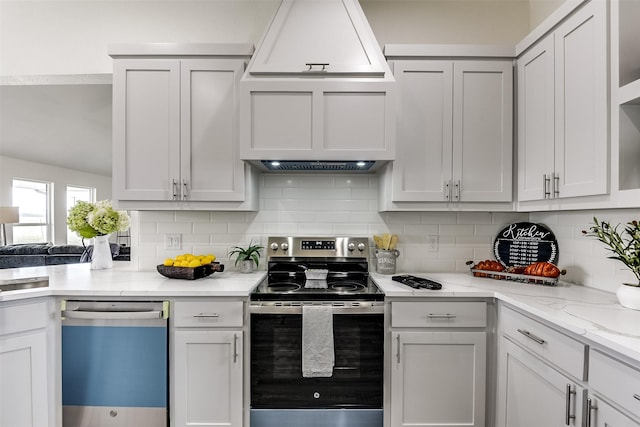 kitchen with appliances with stainless steel finishes, light stone countertops, white cabinetry, and decorative backsplash