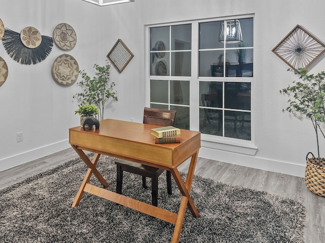 office space with baseboards and wood finished floors