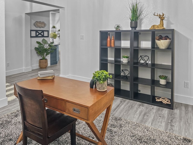 office with baseboards and wood finished floors