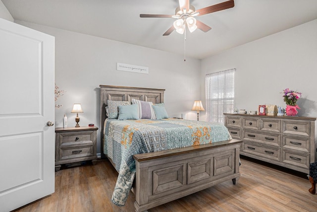 bedroom with ceiling fan and wood finished floors