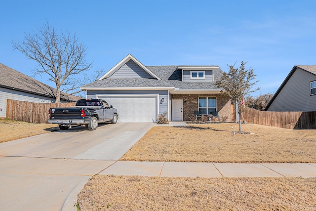 view of front facade with driveway, brick siding, an attached garage, and fence