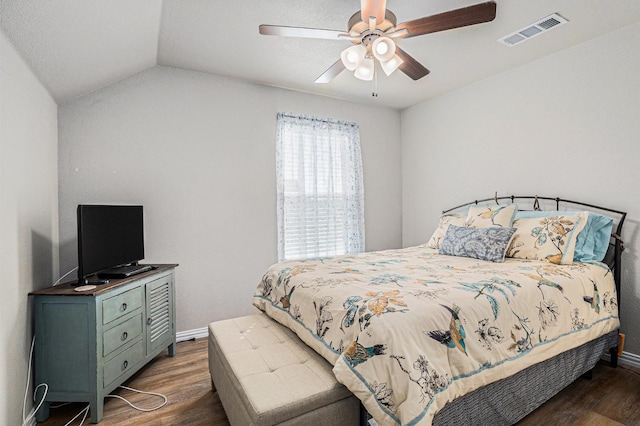 bedroom featuring visible vents, vaulted ceiling, baseboards, and wood finished floors