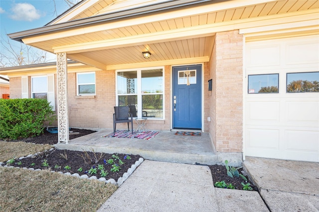 entrance to property with a porch and a garage