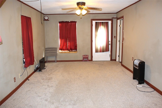 interior space featuring crown molding, light colored carpet, and ceiling fan