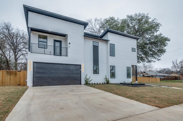 modern home with a balcony, a garage, and a front lawn