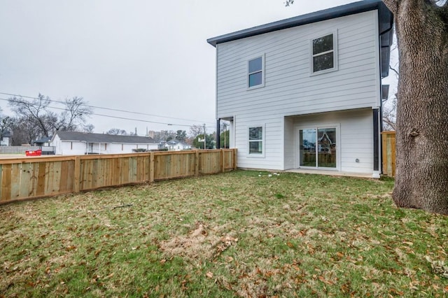 rear view of property with a lawn