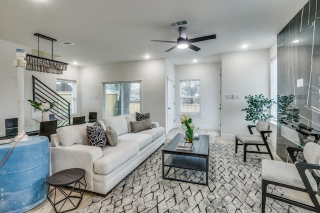 living room featuring light hardwood / wood-style flooring and ceiling fan