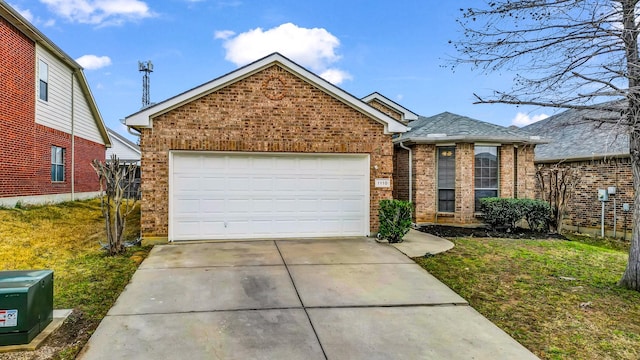 view of front of property featuring a garage and a front lawn