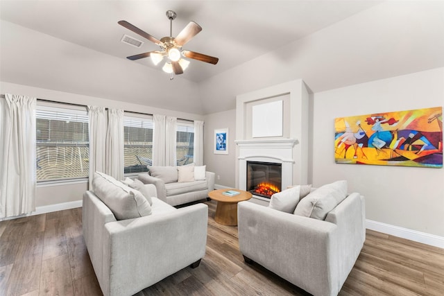 living room with wood-type flooring, lofted ceiling, and ceiling fan