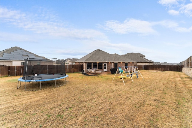 view of yard with a playground and a trampoline