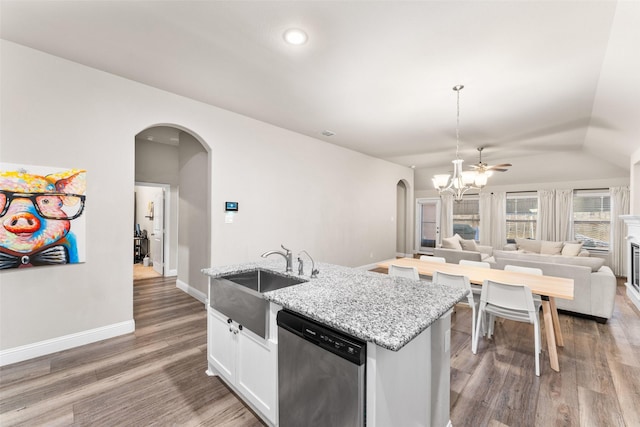 kitchen featuring sink, white cabinetry, light stone counters, dark hardwood / wood-style flooring, and stainless steel dishwasher