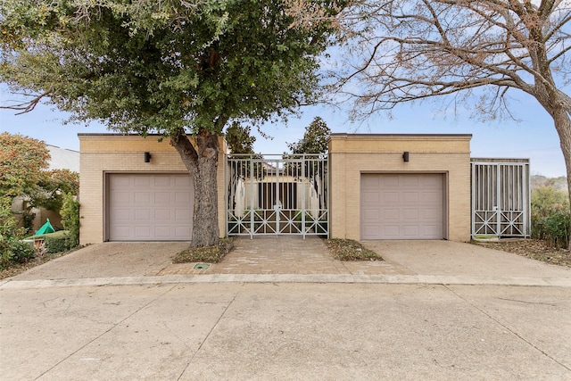 view of front of home featuring brick siding, an outdoor structure, and a gate