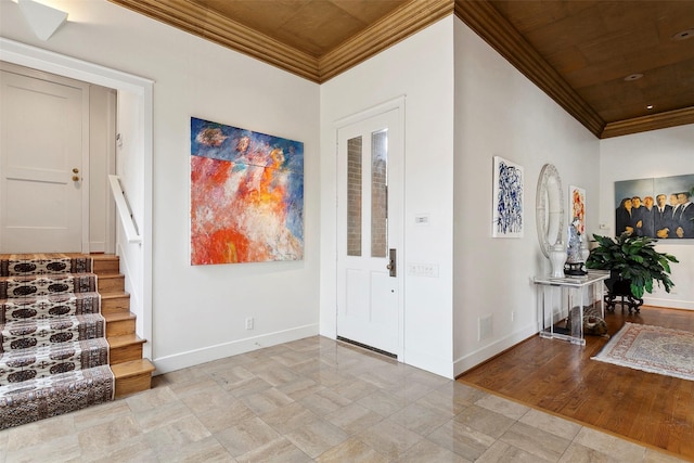 entryway featuring ornamental molding, wood ceiling, baseboards, and stairs