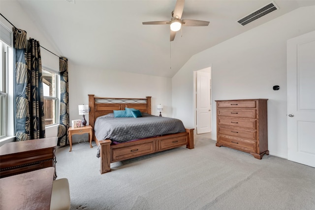 bedroom featuring lofted ceiling, light carpet, and ceiling fan