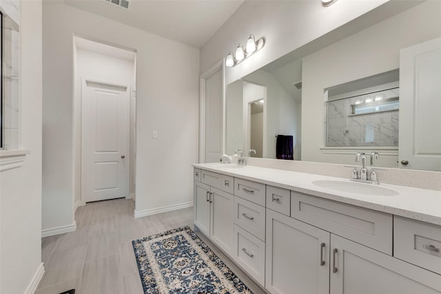 bathroom featuring vanity and a shower with shower door