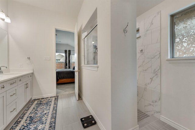 bathroom featuring vanity and tiled shower