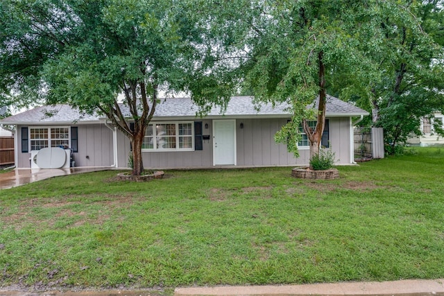 ranch-style home with a front lawn