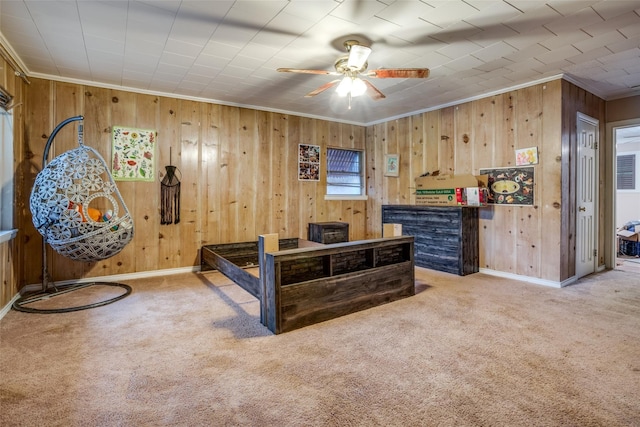 carpeted bedroom with ornamental molding and wooden walls