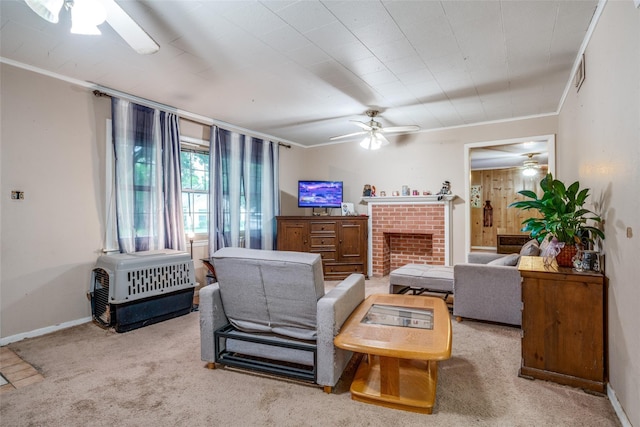 living room with light colored carpet, a fireplace, ornamental molding, and ceiling fan