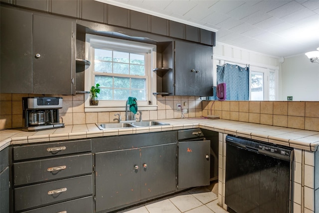 kitchen featuring crown molding, tile counters, black dishwasher, and sink