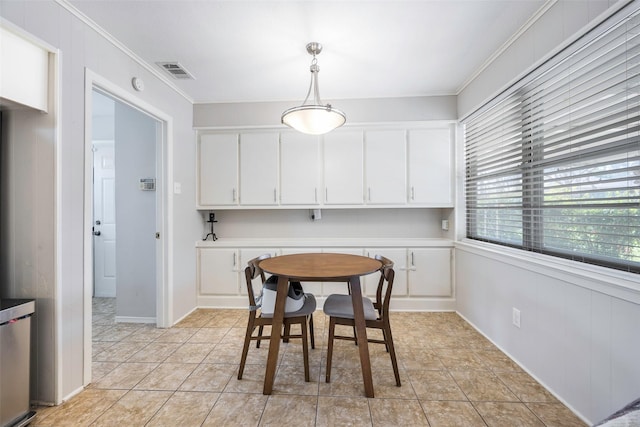 tiled dining space with ornamental molding