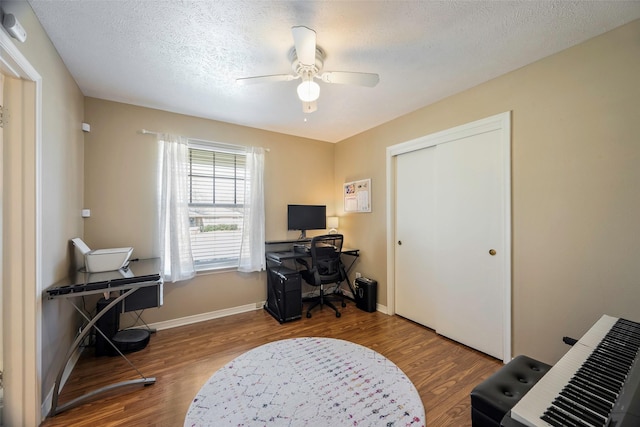 office space featuring hardwood / wood-style flooring, a textured ceiling, and ceiling fan