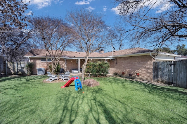 rear view of house with a yard