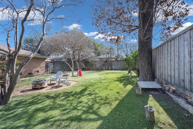 view of yard with an outdoor fire pit