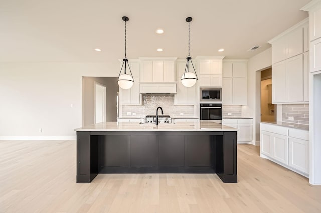 4405 Tower Bluff Rd, Midlothian, TX 76065 - kitchen featuring wall oven, stainless steel microwave, light wood-style flooring, white cabinets, and backsplash